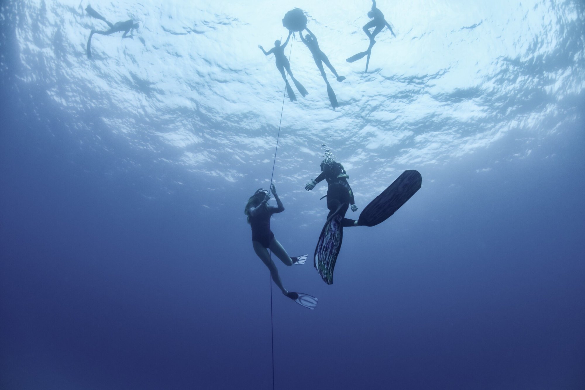 Benefits of Freediving a man standing on a snow board high in the sky