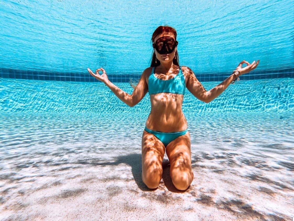 a person standing next to a body of water