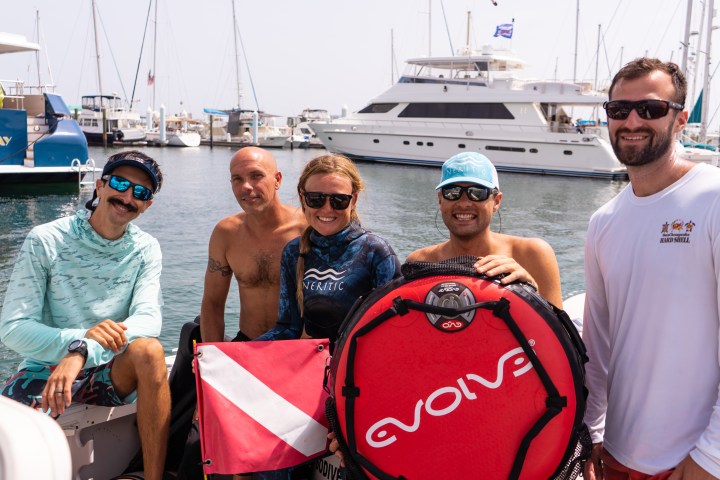 a group of people in a boat on a body of water