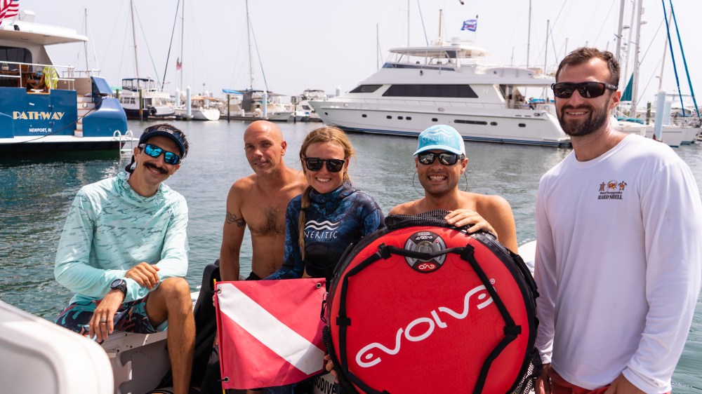 a group of people in a boat on a body of water