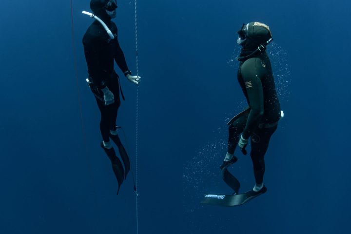 a group of people flying kites in the air