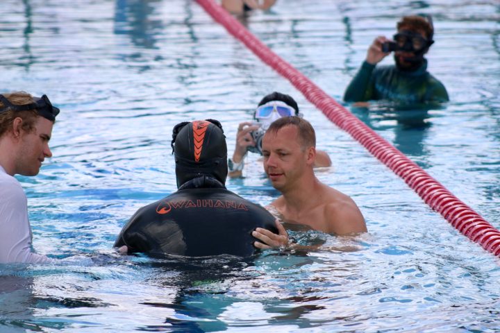 a group of people swimming in a body of water
