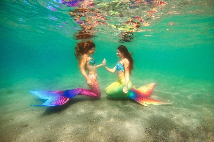 a young girl in a pool of water