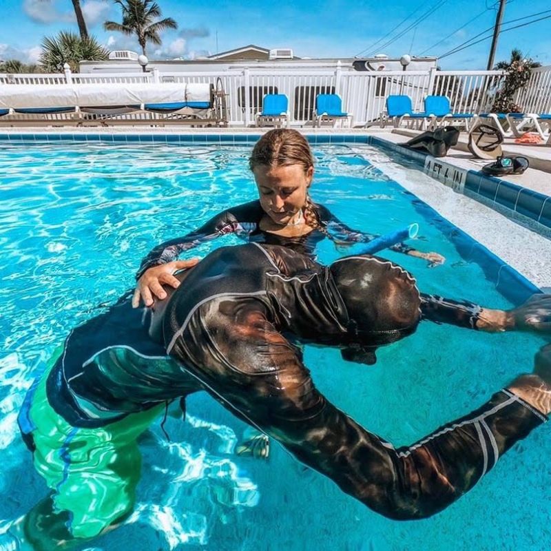 a man swimming in a pool of water