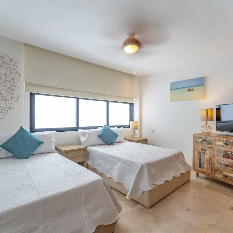 a bedroom with a bed and desk in a room