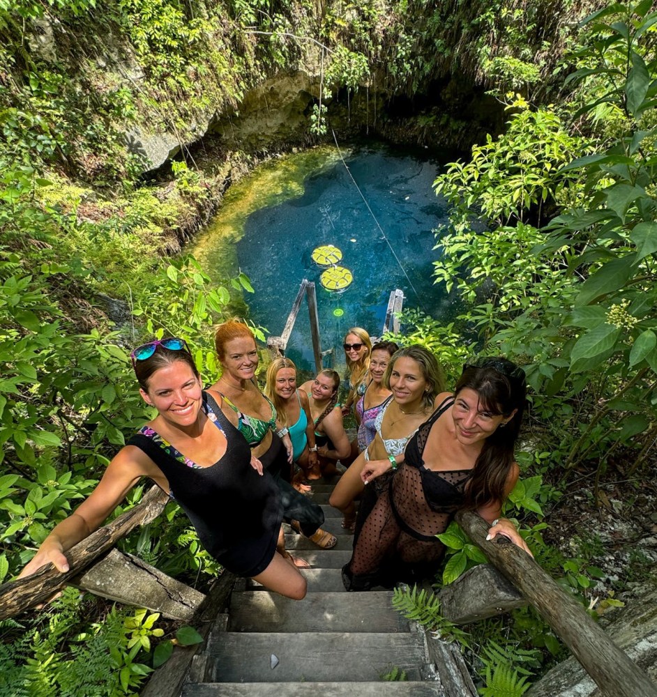 a group of people swimming in a garden
