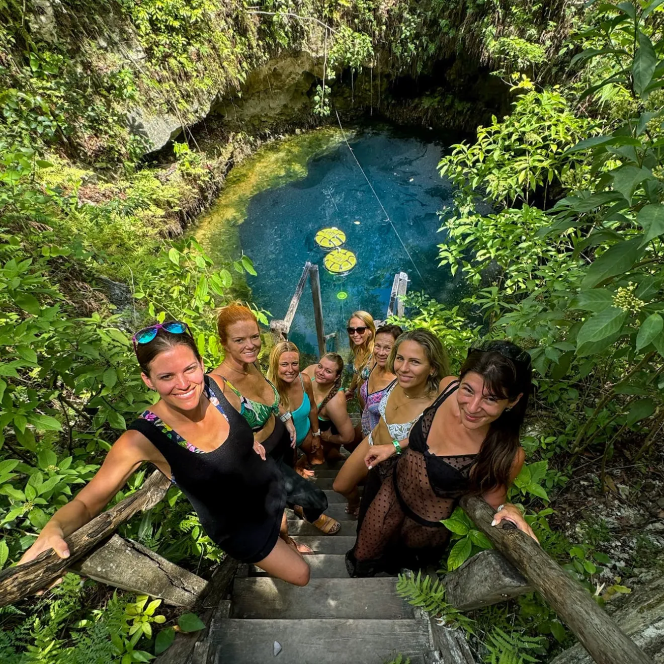 a group of people swimming in a garden
