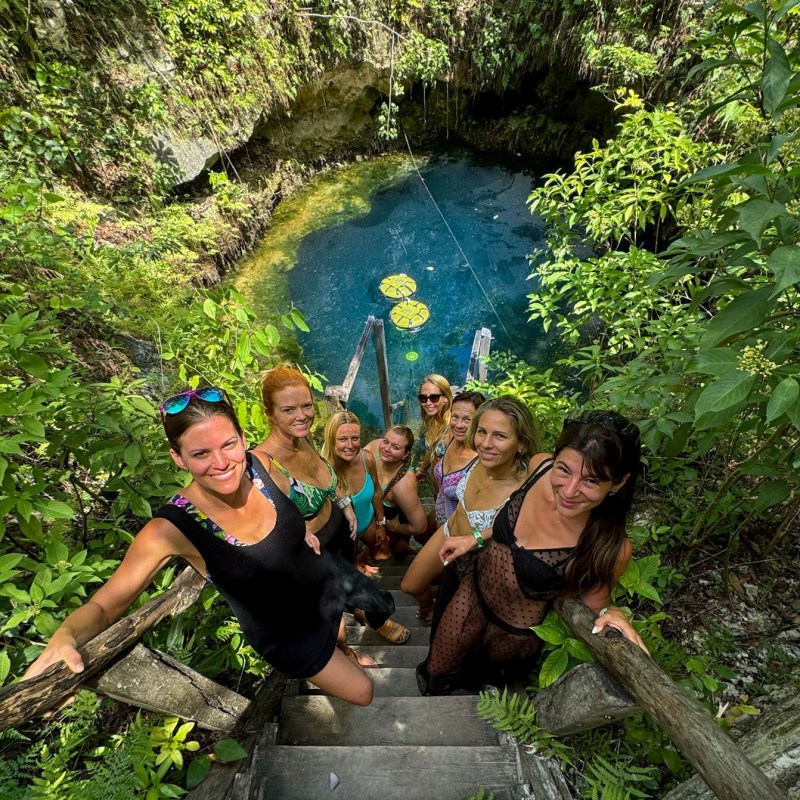 a group of people swimming in a garden