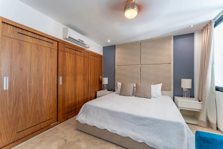 a kitchen with a large bed in a bedroom