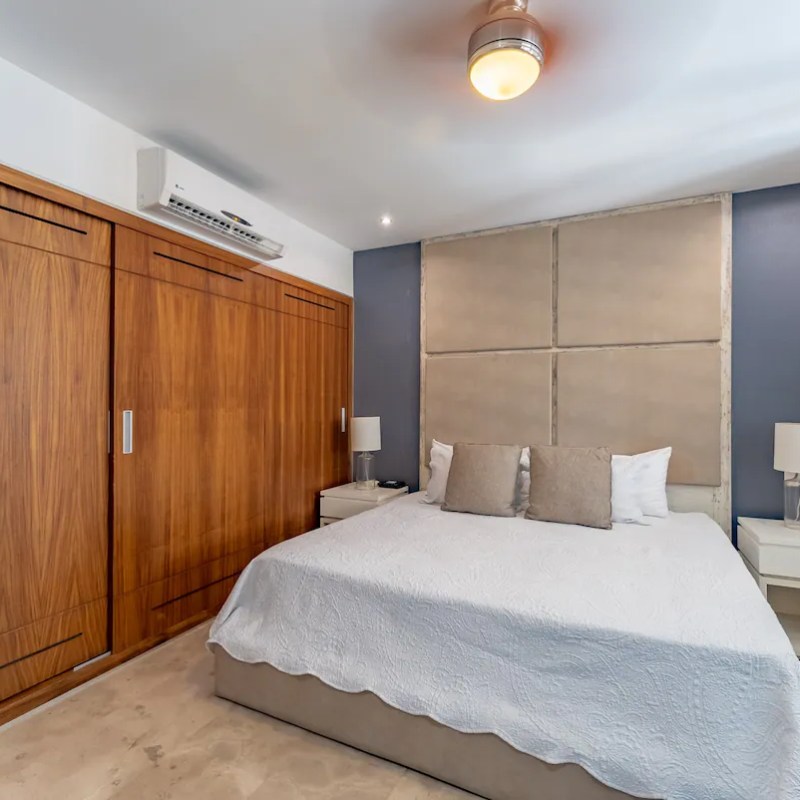 a kitchen with a large bed in a bedroom