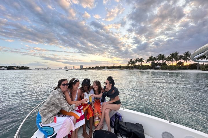 a group of people sitting in a boat on a body of water