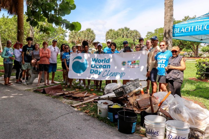 a group of people standing in front of a sign