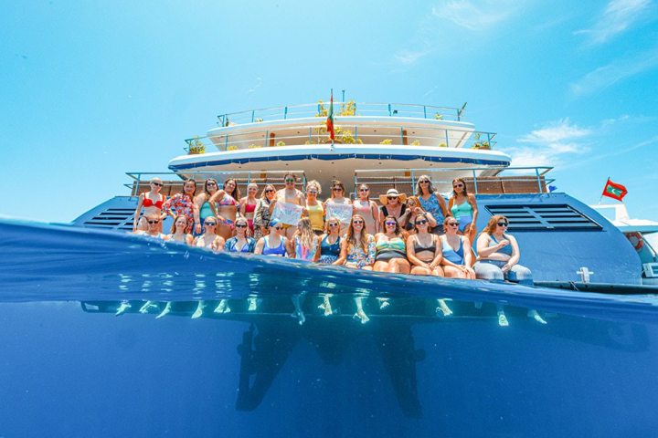 a group of people on a boat in the water