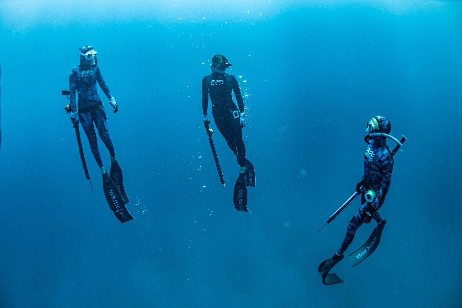 Women learning spearfishing safety and hunting skills