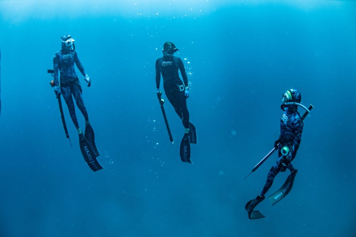 Women learning spearfishing safety and hunting skills